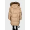 Down jacket with fur on the hood and a tag