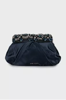 Clutch decorated with rhinestones and drapery