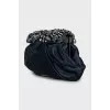 Clutch decorated with rhinestones and drapery
