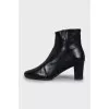 Black leather ankle boots with logo