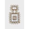 Bottle shaped brooch with logo