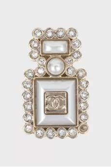 Bottle shaped brooch with logo