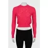 Pink jumper with perforated pattern