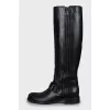 Leather boots decorated with a strap