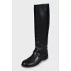 Leather boots decorated with a strap