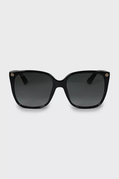 Black sunglasses with gold logo