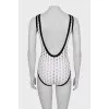 Perforated bodysuit with tag