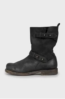 Leather boots decorated with straps