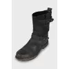 Leather boots decorated with straps