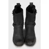Leather boots decorated with straps