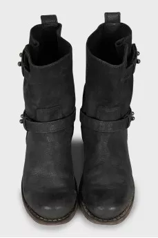 Leather boots decorated with straps
