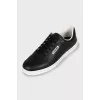 Black leather sneakers with brand logo