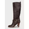 Leather boots decorated with straps