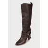Leather boots decorated with straps