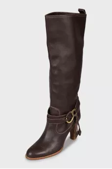 Leather boots decorated with straps