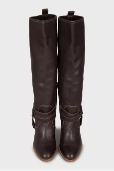 Leather boots decorated with straps