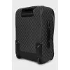 Suitcase made of canvas with a signature print