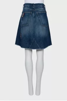 Denim skirt decorated with a patch