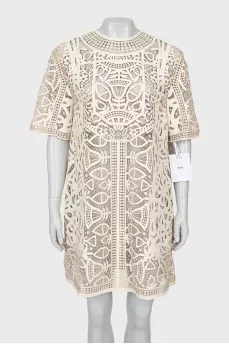 Perforated leather dress with tag