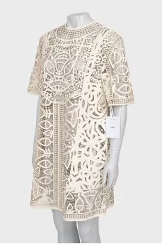 Perforated leather dress with tag