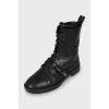 Leather boots decorated with a strap