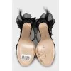 Suede sandals decorated with bows