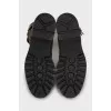 Suede boots decorated with straps