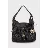 Leather bag decorated with straps