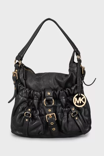 Leather bag decorated with straps