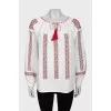 Blouse with wide sleeves decorated with embroidery