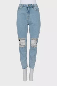 Ripped jeans decorated with crystals