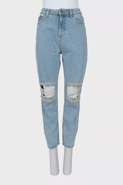 Ripped jeans decorated with crystals