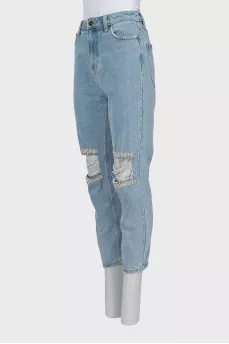 Ripped jeans decorated with crystals
