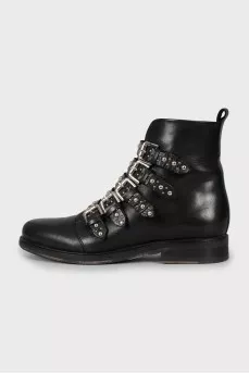 Black leather boots decorated with straps