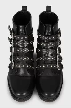 Black leather boots decorated with straps