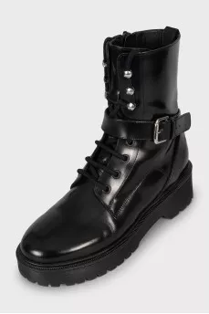 Leather boots decorated with straps