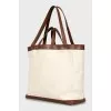 Bag with leather handles and signature print