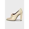 Golden lace-up shoes