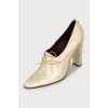 Golden lace-up shoes