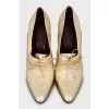 Golden lace-up shoes