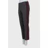 Trousers with red and black stripes on the sides