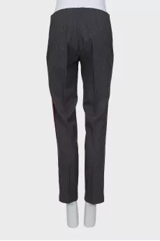 Trousers with red and black stripes on the sides