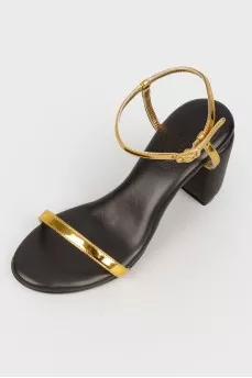 Black sandals with golden straps