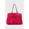 Leather bag decorated with a bow