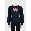 Dark blue sweater with brand logo