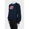Dark blue sweater with brand logo
