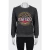 Gray sweatshirt decorated with embroidery