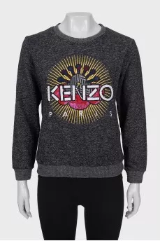 Gray sweatshirt decorated with embroidery