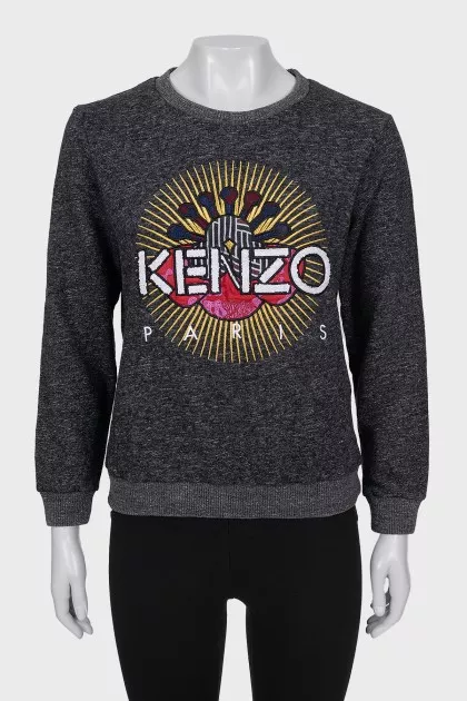 Gray sweatshirt decorated with embroidery