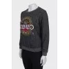 Gray sweatshirt decorated with embroidery